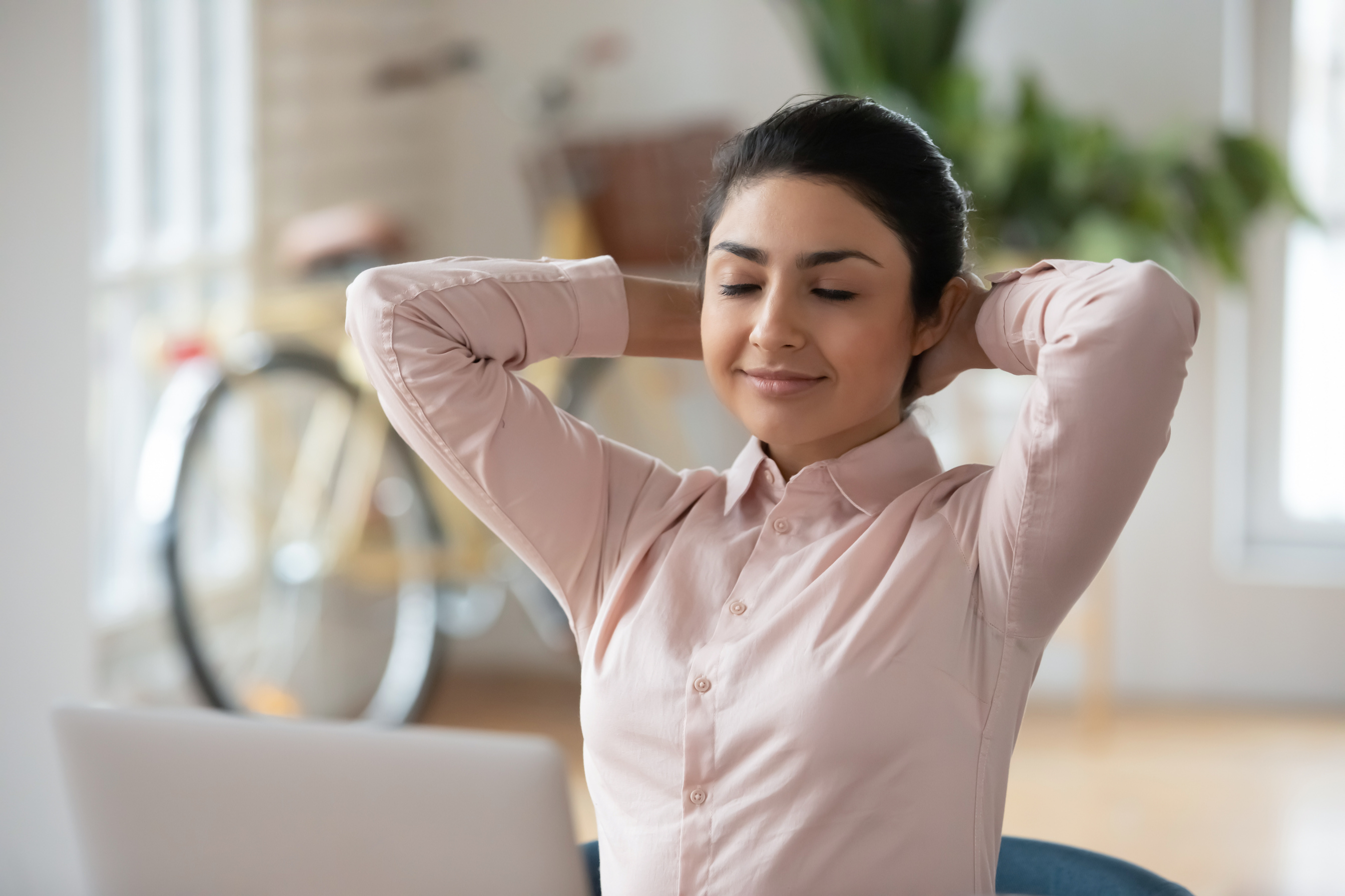 Calm Indian female employee relax at workplace